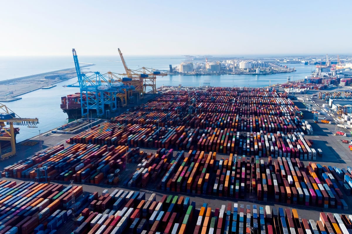 Aerial view of shipping containers and cargo ships in port